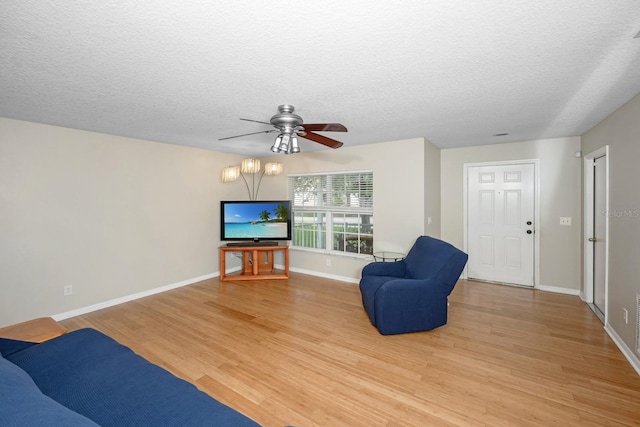 10807 Shasta Ct, Riverview, FL 33569 - living room with light wood-style floors, ceiling fan, and a textured ceiling