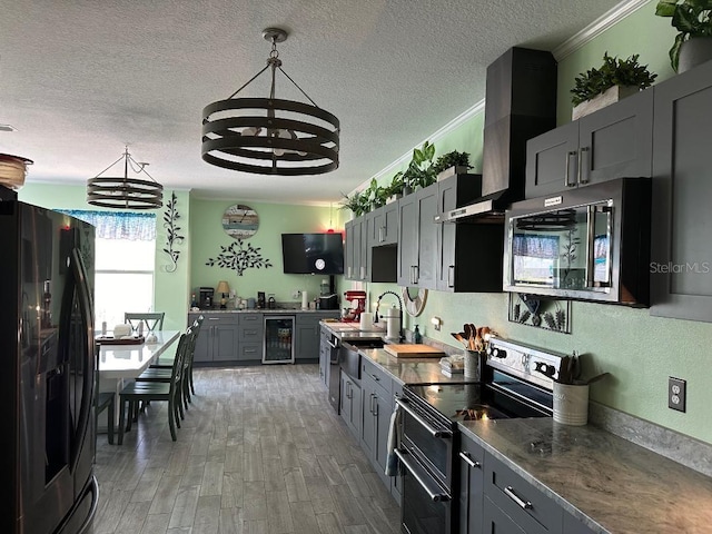 10920 Sailbrooke Dr, Riverview, FL 33579 - kitchen with black refrigerator with ice dispenser, electric stove, stainless steel microwave, beverage cooler, and a chandelier