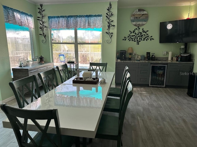 10920 Sailbrooke Dr, Riverview, FL 33579 - dining space featuring beverage cooler, ornamental molding, wood finished floors, and bar