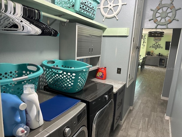 10920 Sailbrooke Dr, Riverview, FL 33579 - laundry room with washing machine and clothes dryer, light wood-type flooring, and beverage cooler