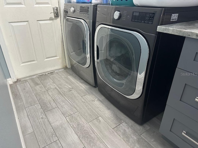 10920 Sailbrooke Dr, Riverview, FL 33579 - laundry area featuring wood tiled floors and washing machine and clothes dryer