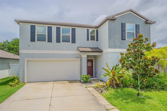 4954 Wild Senna Blvd, Tampa, FL 33619 - view of front of property featuring stucco siding, concrete driveway, and a garage