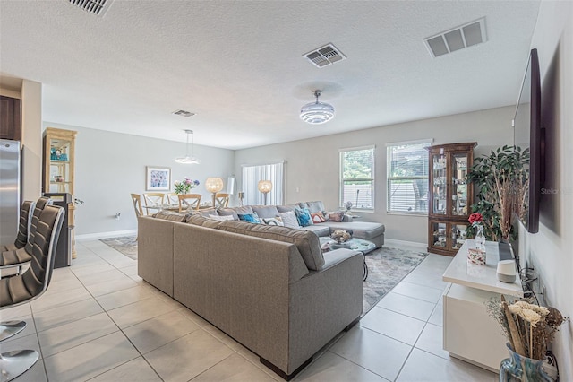 4954 Wild Senna Blvd, Tampa, FL 33619 - living area featuring light tile patterned flooring and a textured ceiling