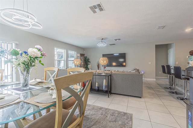 4954 Wild Senna Blvd, Tampa, FL 33619 - dining room featuring light tile patterned floors and a chandelier