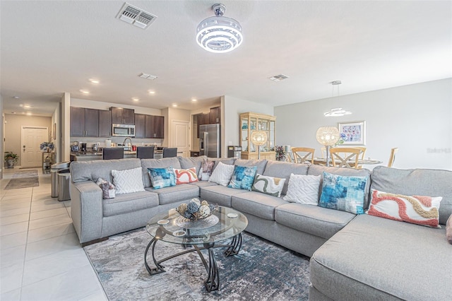 4954 Wild Senna Blvd, Tampa, FL 33619 - living room with light tile patterned floors and recessed lighting