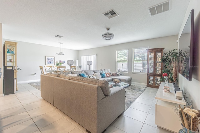 4954 Wild Senna Blvd, Tampa, FL 33619 - living area with light tile patterned floors and a textured ceiling