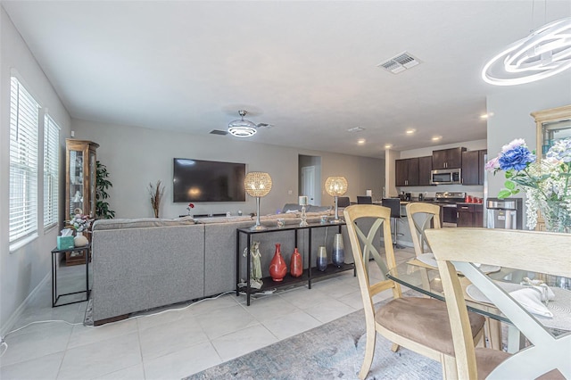 4954 Wild Senna Blvd, Tampa, FL 33619 - living area featuring healthy amount of natural light, light tile patterned floors, recessed lighting, and ceiling fan