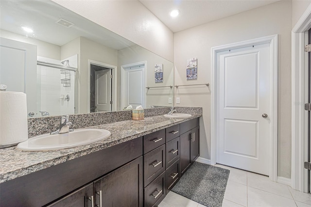 4954 Wild Senna Blvd, Tampa, FL 33619 - full bathroom with double vanity, a stall shower, and tile patterned floors