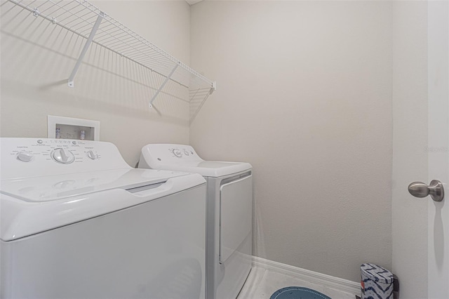 4954 Wild Senna Blvd, Tampa, FL 33619 - washroom with washer and clothes dryer and baseboards