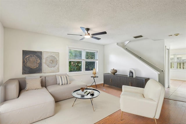 808 Franklin Cir, Palm Harbor, FL 34683 - living room featuring ceiling fan, wood finished floors, and a textured ceiling