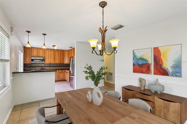 808 Franklin Cir, Palm Harbor, FL 34683 - dining space with light tile patterned flooring, plenty of natural light, and a chandelier