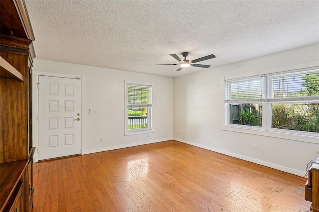 808 Franklin Cir, Palm Harbor, FL 34683 - foyer featuring a ceiling fan, a textured ceiling, and light wood-type flooring