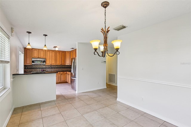 808 Franklin Cir, Palm Harbor, FL 34683 - kitchen with appliances with stainless steel finishes, plenty of natural light, a chandelier, and dark countertops