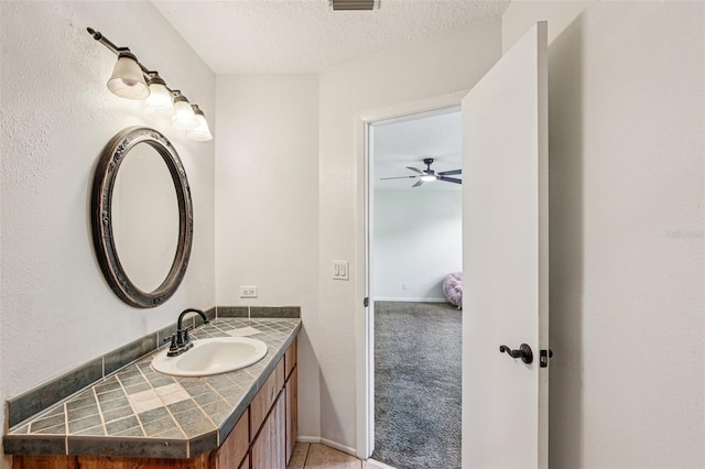 808 Franklin Cir, Palm Harbor, FL 34683 - bathroom featuring vanity, ceiling fan, and a textured ceiling