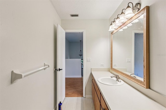 808 Franklin Cir, Palm Harbor, FL 34683 - bathroom with vanity, tile patterned floors, and a textured ceiling