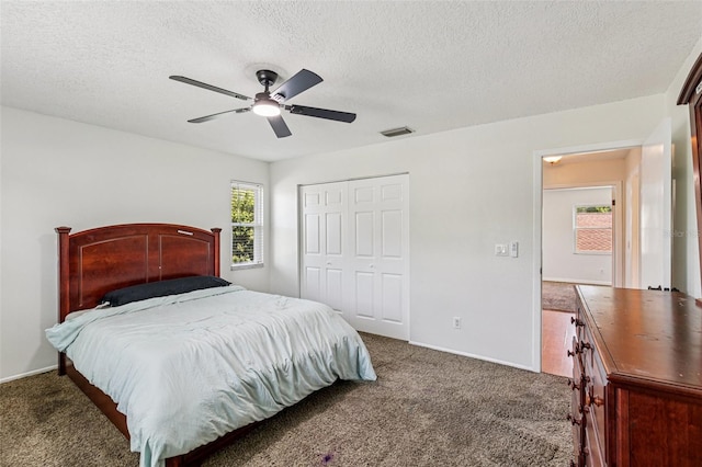 808 Franklin Cir, Palm Harbor, FL 34683 - carpeted bedroom featuring a textured ceiling, a closet, and ceiling fan