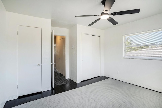 11830 86th Ave, Seminole, FL 33772 - unfurnished bedroom featuring dark wood finished floors, a closet, and a ceiling fan