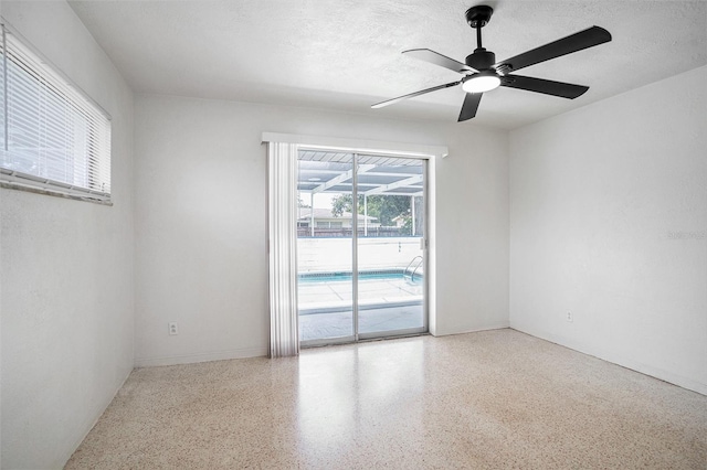 11830 86th Ave, Seminole, FL 33772 - spare room with speckled floor, ceiling fan, and a textured ceiling