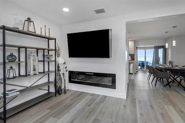 2630 St Josephs Dr W, Dunedin, FL 34698 - living area with light wood-style floors and recessed lighting