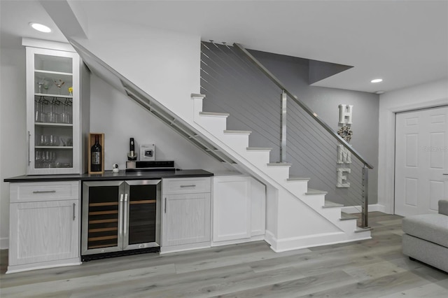 2630 St Josephs Dr W, Dunedin, FL 34698 - indoor wet bar with beverage cooler, stairway, light wood finished floors, and recessed lighting