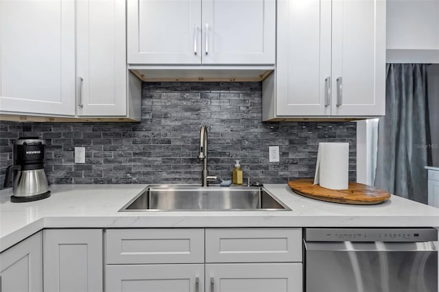 2630 St Josephs Dr W, Dunedin, FL 34698 - kitchen featuring dishwasher, backsplash, and white cabinetry