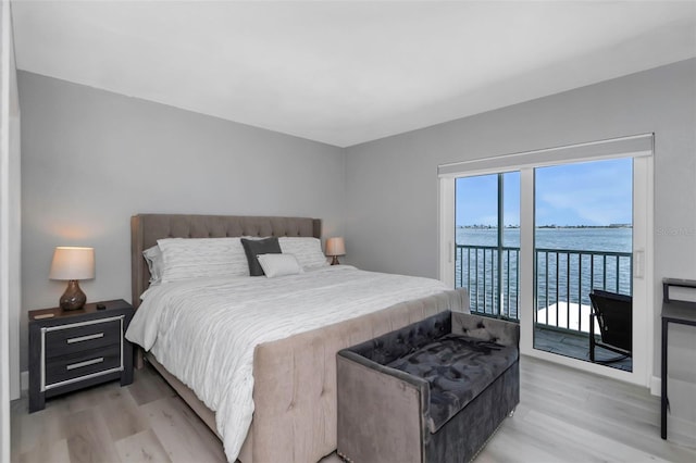 2630 St Josephs Dr W, Dunedin, FL 34698 - bedroom featuring light wood-style floors, access to outside, and a water view
