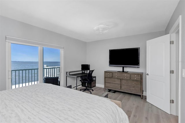 2630 St Josephs Dr W, Dunedin, FL 34698 - bedroom with access to outside and light wood-style flooring