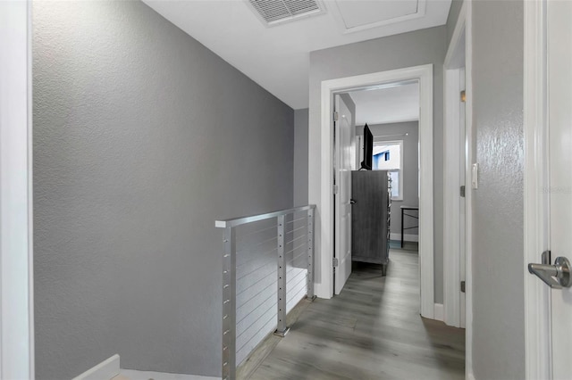 2630 St Josephs Dr W, Dunedin, FL 34698 - hall with wood finished floors, an upstairs landing, and a textured wall