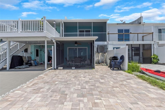 2630 St Josephs Dr W, Dunedin, FL 34698 - rear view of property featuring a ceiling fan and a sunroom