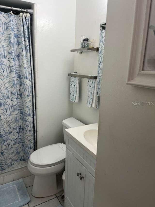 4487 Anderson Rd, Orlando, FL 32812 - bathroom with tile patterned floors, vanity, and a shower with curtain