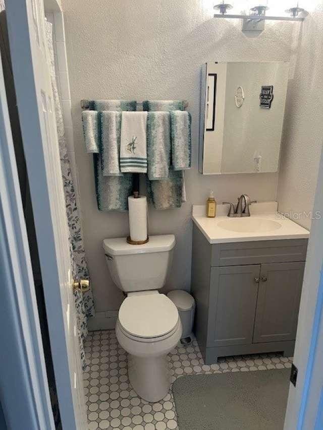 4487 Anderson Rd, Orlando, FL 32812 - bathroom featuring vanity, a textured wall, and tile patterned floors