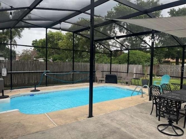 4487 Anderson Rd, Orlando, FL 32812 - view of pool with a fenced backyard, a patio area, and a lanai