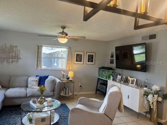 4487 Anderson Rd, Orlando, FL 32812 - living area featuring a textured ceiling, light tile patterned floors, and a ceiling fan