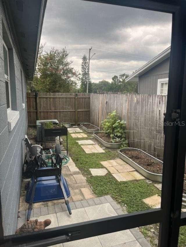 4487 Anderson Rd, Orlando, FL 32812 - fenced yard featuring a garden
