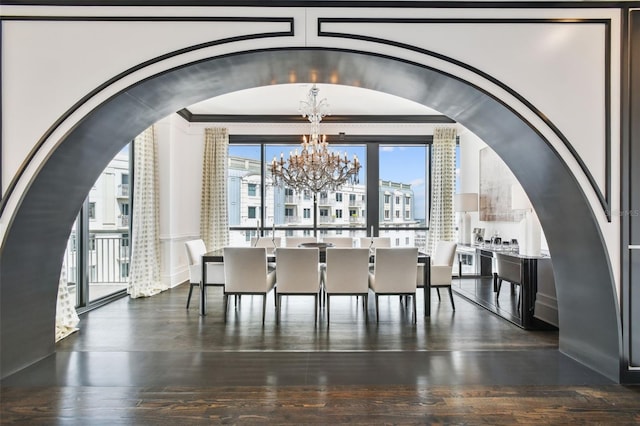 450 Knights Run Ave Unit 2004, Tampa, FL 33602 - dining space with a chandelier, crown molding, arched walkways, and wood finished floors