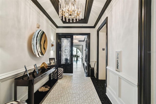 450 Knights Run Ave Unit 2004, Tampa, FL 33602 - entryway featuring a chandelier, ornamental molding, a decorative wall, and a wainscoted wall