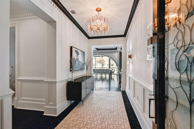 450 Knights Run Ave Unit 2004, Tampa, FL 33602 - hallway with a decorative wall, a chandelier, inlaid floor details, ornamental molding, and a wainscoted wall