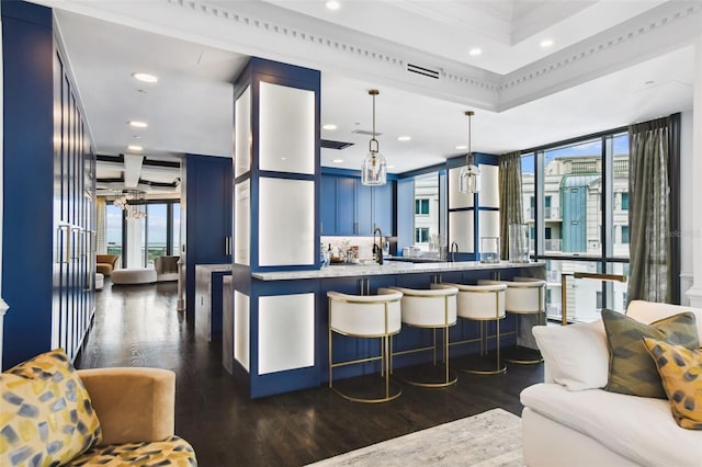 450 Knights Run Ave Unit 2004, Tampa, FL 33602 - kitchen with blue cabinetry, dark wood finished floors, a kitchen bar, light countertops, and recessed lighting
