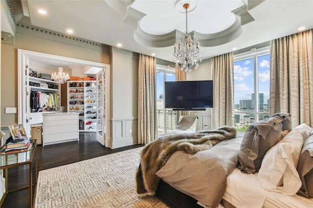 450 Knights Run Ave Unit 2004, Tampa, FL 33602 - bedroom with a chandelier, a spacious closet, wood finished floors, access to exterior, and recessed lighting
