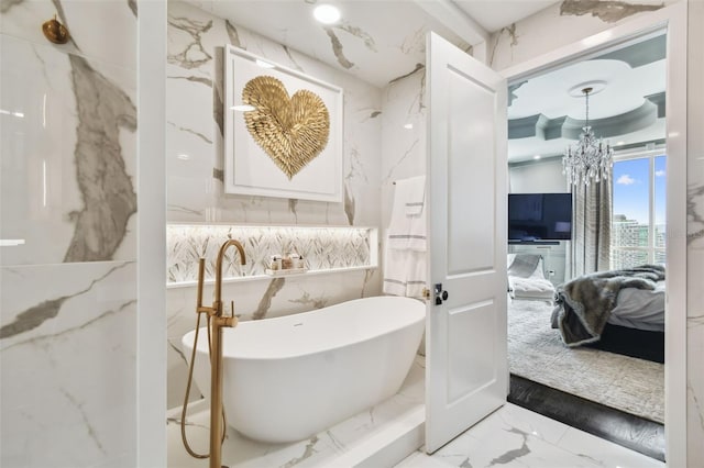 450 Knights Run Ave Unit 2004, Tampa, FL 33602 - bathroom with marble tiled flooring, ensuite bathroom, stone wall, and a freestanding bath