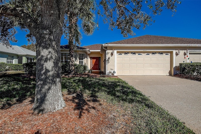 29417 Caddyshack Ln, San Antonio, FL 33576 - ranch-style home with stucco siding, a garage, and driveway
