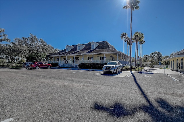 29417 Caddyshack Ln, San Antonio, FL 33576 - view of front facade with uncovered parking and a porch