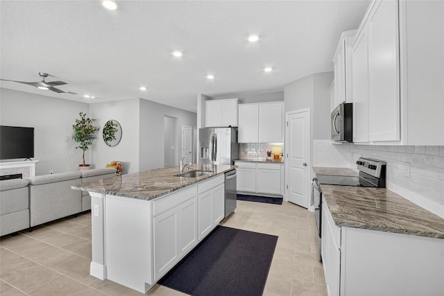 5657 Hawks Cay St, Apollo Beach, FL 33572 - kitchen with appliances with stainless steel finishes, open floor plan, tasteful backsplash, white cabinetry, and recessed lighting