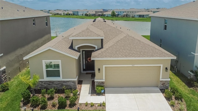 5657 Hawks Cay St, Apollo Beach, FL 33572 - ranch-style home with stone siding, a residential view, and a water view