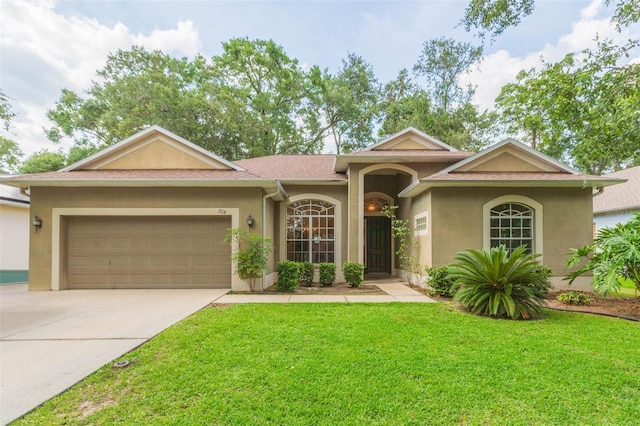 228 Taylor Bay Ln, Brandon, FL 33510 - ranch-style house featuring stucco siding, concrete driveway, a front yard, and an attached garage