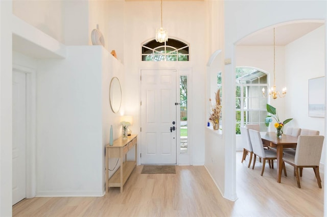 228 Taylor Bay Ln, Brandon, FL 33510 - foyer entrance with a chandelier, light wood-type flooring, and a high ceiling