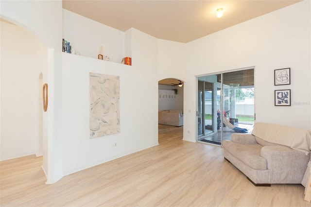 228 Taylor Bay Ln, Brandon, FL 33510 - living area featuring arched walkways, light wood-style floors, and a towering ceiling