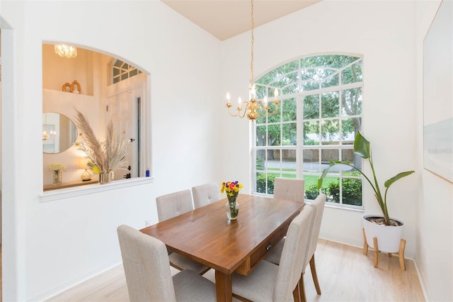 228 Taylor Bay Ln, Brandon, FL 33510 - dining space with a chandelier, wood finished floors, and arched walkways