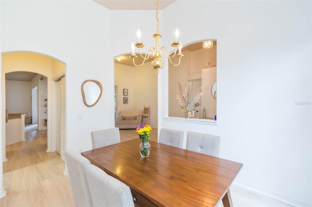 228 Taylor Bay Ln, Brandon, FL 33510 - dining room featuring arched walkways and a chandelier
