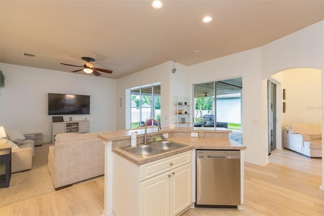 228 Taylor Bay Ln, Brandon, FL 33510 - kitchen featuring stainless steel dishwasher, open floor plan, light wood-style flooring, a ceiling fan, and arched walkways